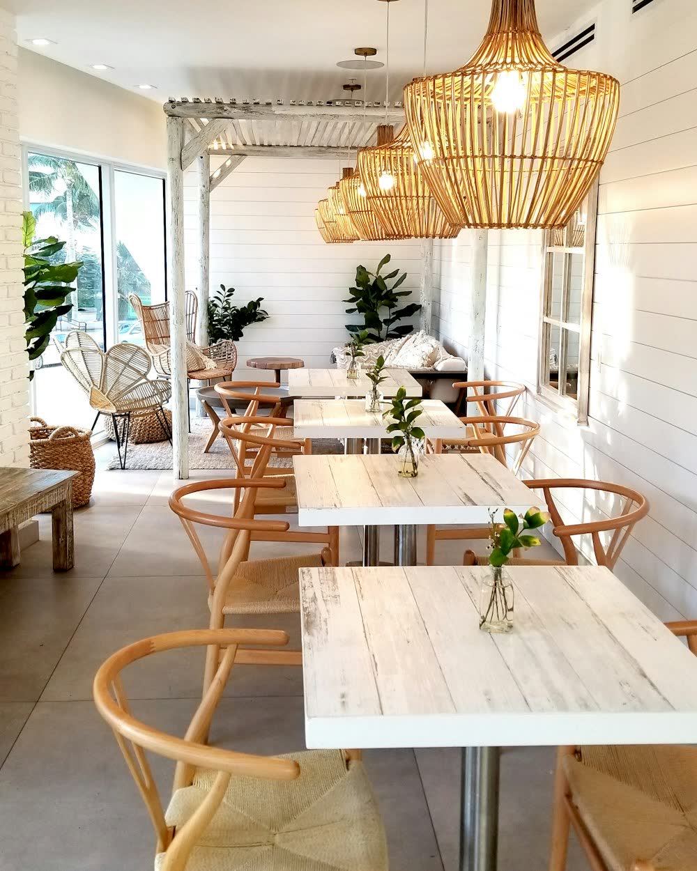A light, airy cafe dining room set for service